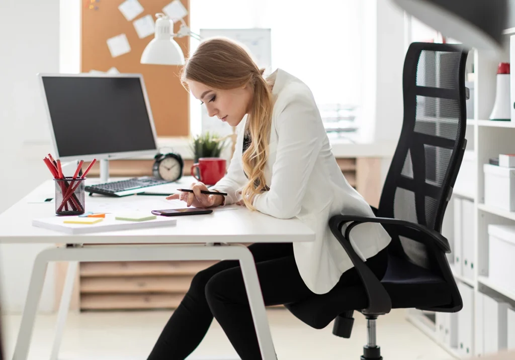 A solopreneur working at her desk implementing strategies to boost productivity