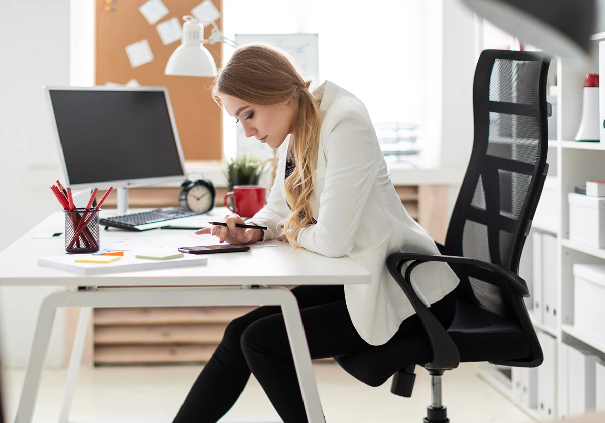 A solopreneur working at her desk implementing strategies to boost productivity
